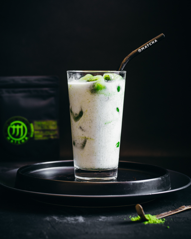 M Matcha ice cubes with coconut milk in a glass